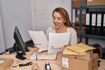 Young woman ecommerce busines worker reading document working at office