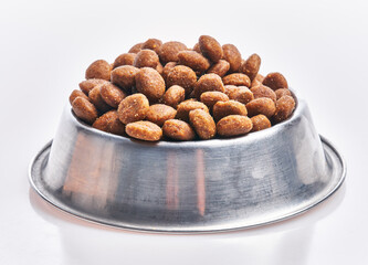  Delicious bowl of dog food balls over isolated white background