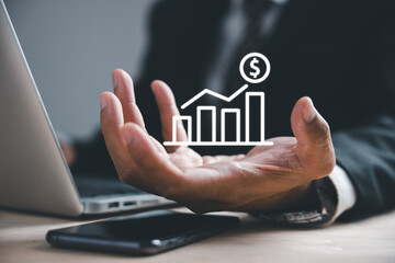 Concept of business development to success and growing growth symbolized by businessman holding arrow graph on palm. Corporate future growth plan in hand illustrates the journey.