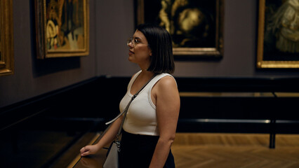 Fototapeta na wymiar Young beautiful hispanic woman visiting art gallery at Art Museum in Vienna