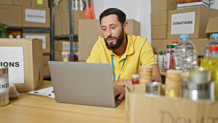 Young hispanic man volunteer smiling confident having video call at charity center