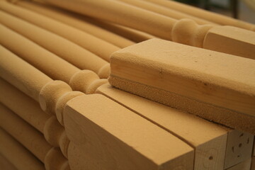 A close-up of some wooden objects in a workshop, pieces of future furniture.