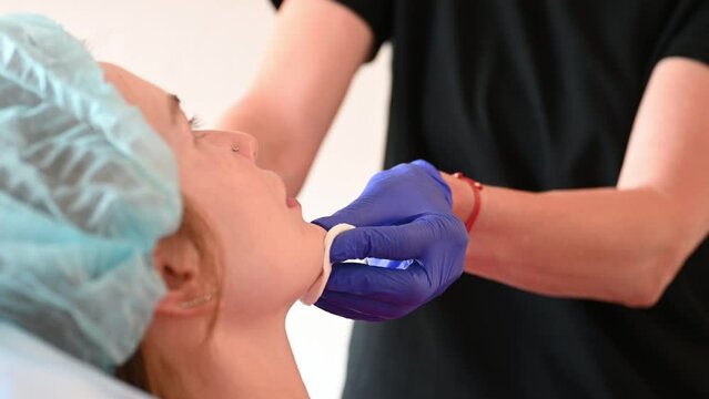 Cosmetologist injects substance in patient modifying face to make non-surgical correction. Filler injections. Aesthetic corrective treatments concept.