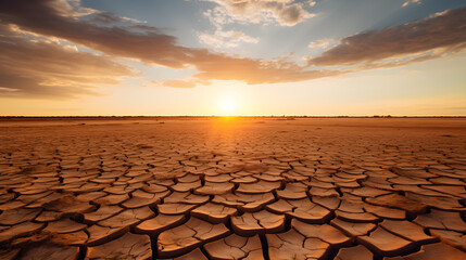 Dry cracked earth at sunset, global warming, climate change concept