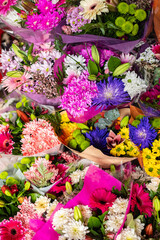 Beautiful bouquets of various flowers are presented in a flower shop. Different varieties fresh spring flowers