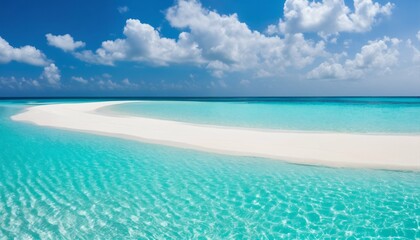 Fototapeta premium Sandy beach featuring white sand and rolling calm wave of turquoise ocean on sunny day, white clouds in blue sky background