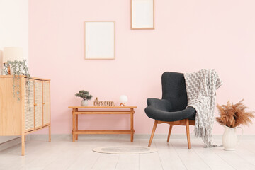 Grey armchair with blanket in living room