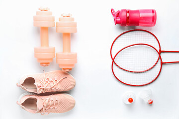 Set of sports equipment with shoes on white background