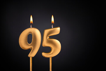 Birthday candle number 95 - Birthday celebration on black background