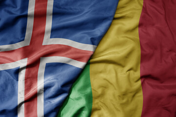 big waving national colorful flag of icelandic and national flag of mali .