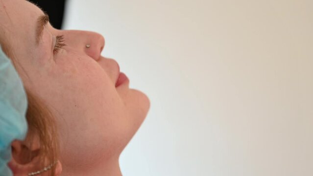 Cosmetologist injects substance in patient modifying face to make non-surgical correction. Filler injections. Aesthetic corrective treatments concept.