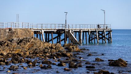 The iconic Second Valley jetty with a man fishing located on the Fleurieu Peninsula South Australia taken on September 11th 2023