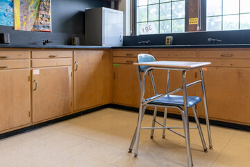 Example of an empty nondescript US High School Classroom with desks.	