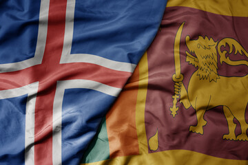 big waving national colorful flag of icelandic and national flag of sri lanka .