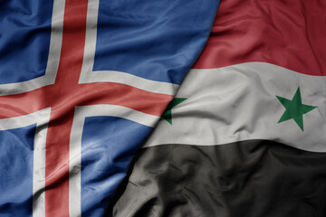 big waving national colorful flag of icelandic and national flag of syria .