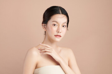 Beautiful young asian woman with clean fresh skin on beige background, Face care, Facial treatment, Cosmetology, beauty and spa, Asian women portrait.