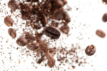 Coffee bean powder fly explosion, Coffee crushed ground float pouring, wave like smoke smell. Coffee bean powder splash throwing in mid Air. White background Isolated selective focus blur