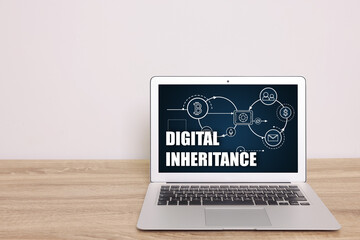Laptop with text Digital Inheritance and scheme with many different icons on screen. Workplace with...