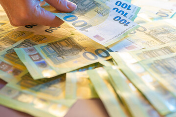 Euro money.Hands collecting money.Hands counting money .Euro currency inflation.100 euro...