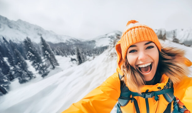 Young happy woman in yellow ski gear taking selfie at snow landscape in mountain peak. Winter vacations travel concept
