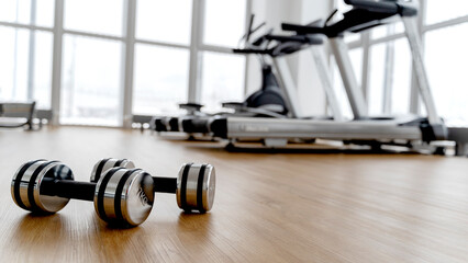dumbbells in the gym on the floor, the concept of proper nutrition and fitness, a place for the...
