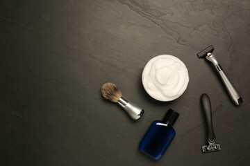 Set of men's shaving tools on black textured table, flat lay. Space for text