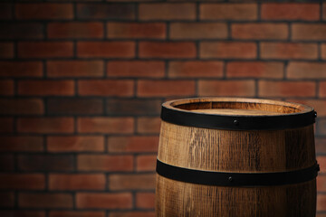 Wooden barrel near brick wall. Space for text