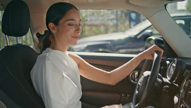 Confident woman driver sitting expensive car looking smartphone message close up