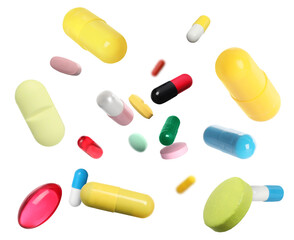 Many different colorful pills falling on white background