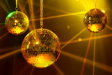 Shiny bright disco balls under color lights