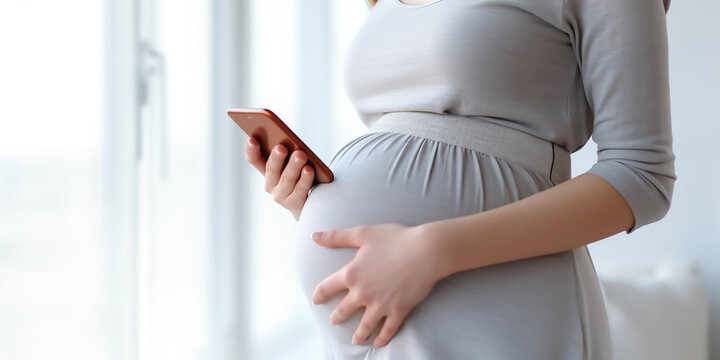 Pregnant woman searches for information on a mobile phone
