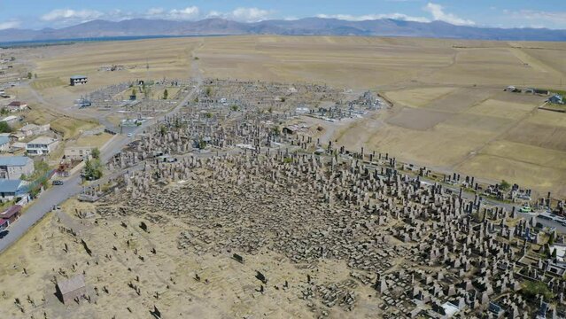 Drone footage of Noratus cemetery, village and Sevan Lake on sunny summer day. Gegharkunik Province, Armenia.