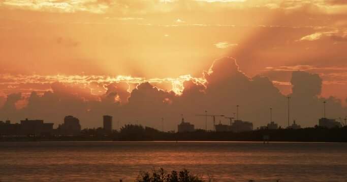 Miami clouds morning dawn sun rays time lapse across water