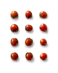 Closeup of fresh juicy organic red cherry tomatoes from the garden isolated on a white background from above, top view
