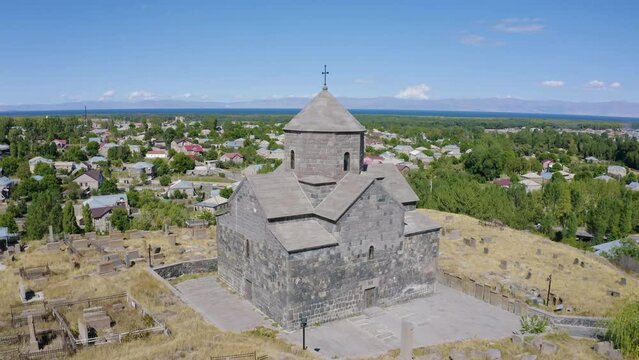 Orbital aerial shot of Kotavank Monastery on sunny summer day. Nerkin Getashen village, Gegharkunik Province, Armenia.