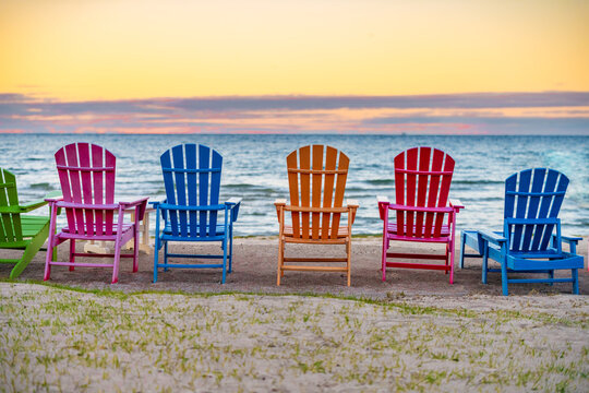 Colorful chairs on the shore of Lake Michigan Door County Wisconsin sunset