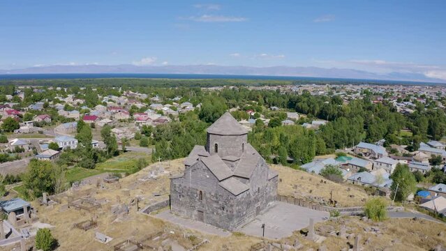 Forward reveal aerial shot of Kotavank Monastery on sunny summer day. Nerkin Getashen, Gegharkunik Province, Armenia.