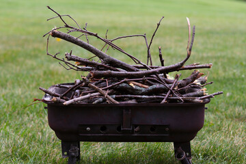 Dry branches stacked on the grill and prepared for campfire.