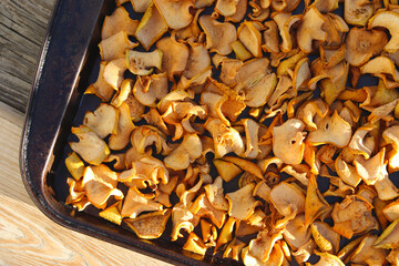 Dry chopped apples on a tray. Beautiful autumn food background. Dry fruits.