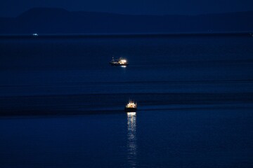 Hokkaido, Japan - September 7, 2023: Fishing boats at dawn on Nemuro strait near Shiretoko Peninsula, Hokkaido, Japan
