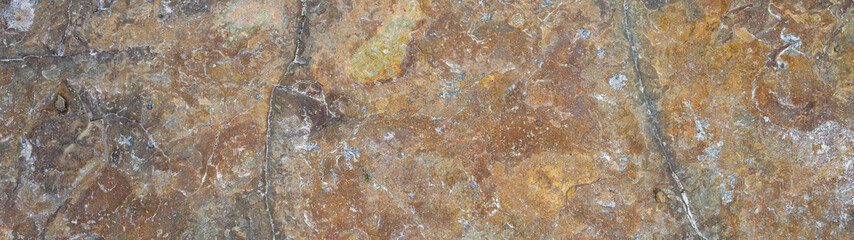 Textured flat rock in warm fall colors as a nature background
