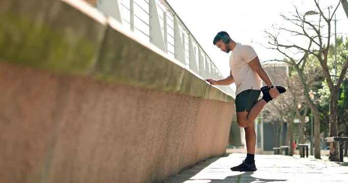 Man, stretching and exercise with music headphones in city for a workout or training. Athlete person outdoor on urban street for legs warm up, streaming and listening to audio for performance and run