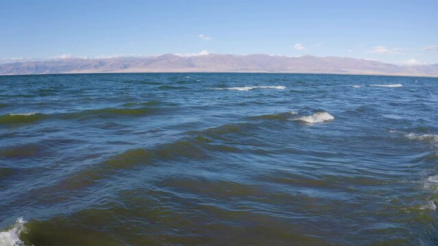 Tripod aerial shot of Sevan Lake on sunny summer day. Karchaghbyur, Gegharkunik Province, Armenia.
