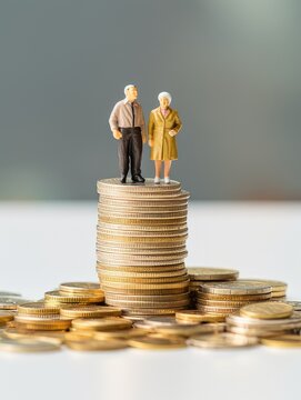 plastic model senior married couple standing on a stack of coins. concept to show retirement and retirement savings. generative AI
