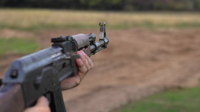 Holding Machine Gun and shooting