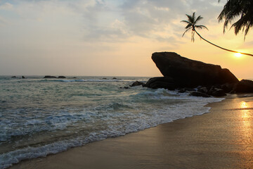 Famous rock at Delawella beach in Sri Lanka during the sunset