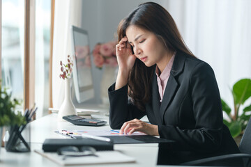 Stressed female employee feeling tired at work, suffering from headache, stress at work or migraine..