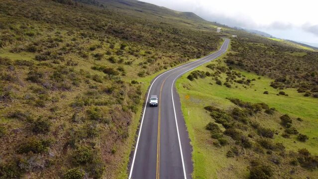 a car transiting a road in a mountain in Oahu