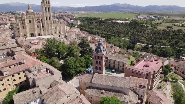 Segovia's Aerial: Iglesia de San Esteban and Segovia Cathedral amidst cityscape