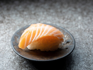 Sliced salmon sushi on a plate	